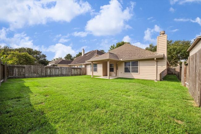 The large backyard provides ample space for gardening, play, or even adding a pool, offering endless possibilities for enjoyment. The siding was recently painted for a fresh new look! This outdoor space is a true extension of the home. Let your lifestyle lead the way! | Image 26