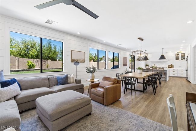 Living room with a ceiling fan, visible vents, recessed lighting, and light wood-style floors | Image 21