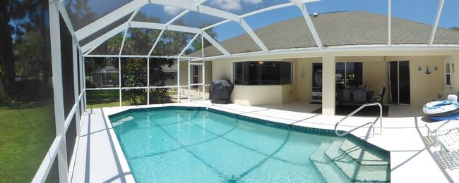 huge pool area with high screened cage | Image 30