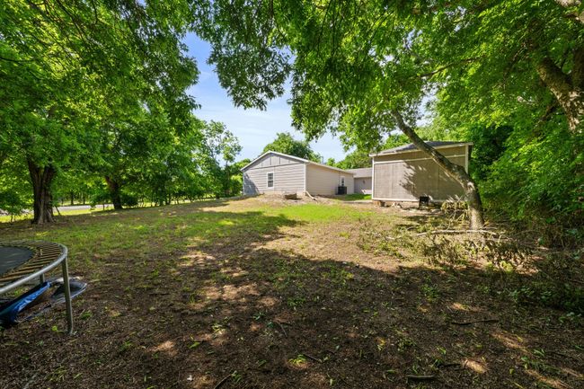 View of yard featuring a trampoline | Image 24