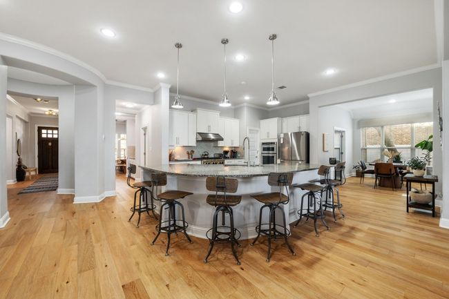Gather round this incredible workhorse of a kitchen island that holds six comfortably. Plenty of counterspace for gadgets and small appliances. Pendant lighting ties it all together. | Image 13
