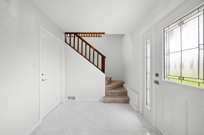 Entrance foyer featuring marble finish floor, baseboards, stairs, and visible vents | Image 17