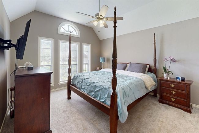 Bedroom with lofted ceiling, light carpet, ceiling fan, and baseboards | Image 20