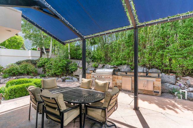 View of patio / terrace with a sink, an outdoor kitchen, area for grilling, outdoor dining space, and a lanai | Image 99