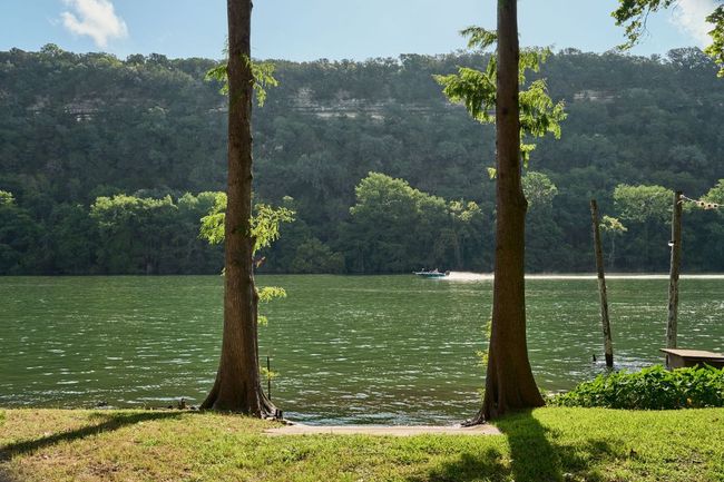 Water view featuring a heavily wooded area | Image 17
