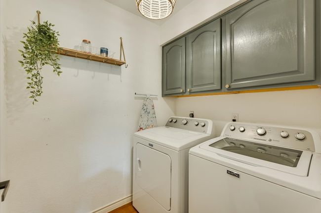 Washroom with washing machine and dryer and cabinet space | Image 14