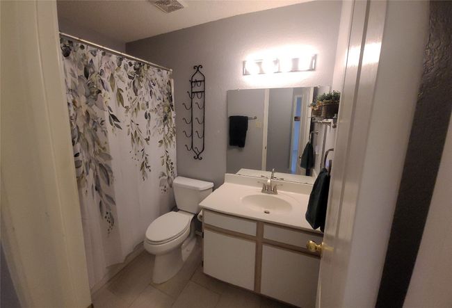 Bathroom featuring a vanity and tile patterned floors | Image 14