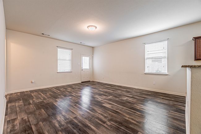 Spare room with dark wood-style flooring and baseboards | Image 13