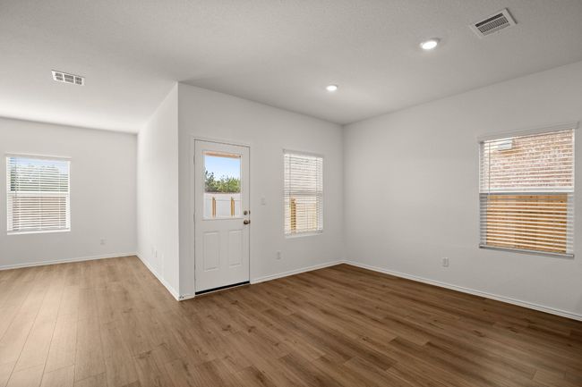 Foyer with a wealth of natural light, wood finished floors, and visible vents | Image 8