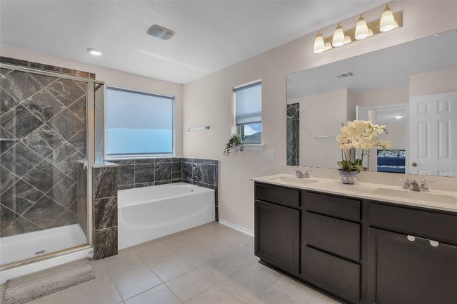 Full bathroom with tile patterned flooring, a garden tub, plenty of natural light, and double vanity | Image 29