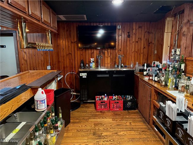Indoor bar featuring light wood finished floors and wooden walls | Image 18