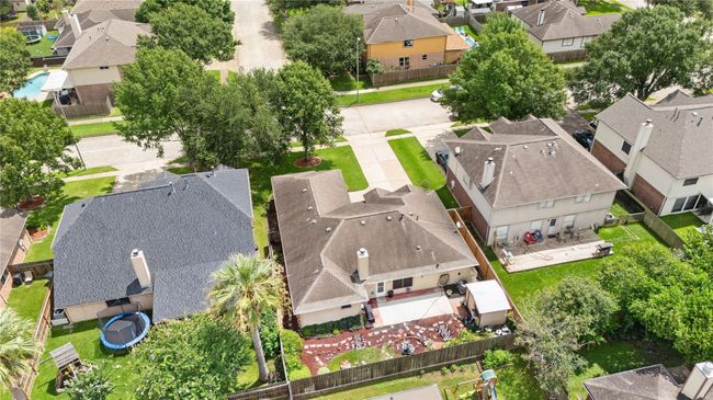 This aerial shot captures the cozy feel of the backyard, lovingly landscaped and full of character. | Image 23