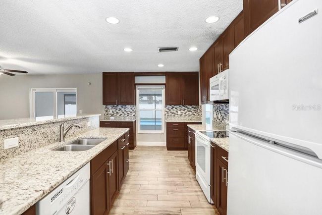 Kitchen with beautiful 42 inch cabinets, granite countertops and beautiful backsplash | Image 4