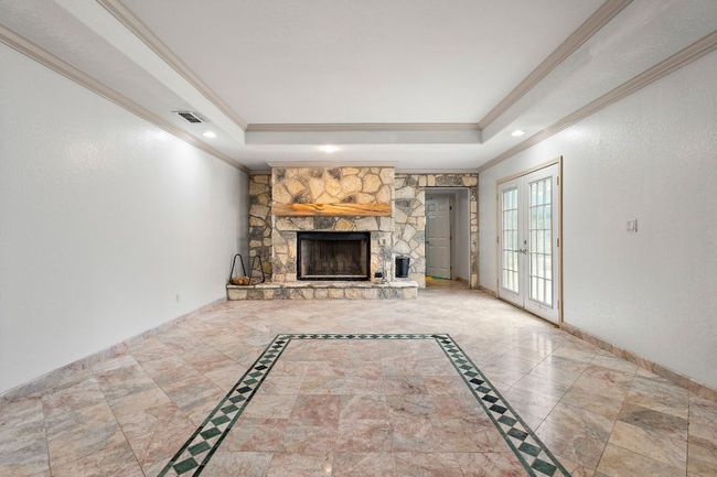 Pool house room featuring fireplace | Image 31