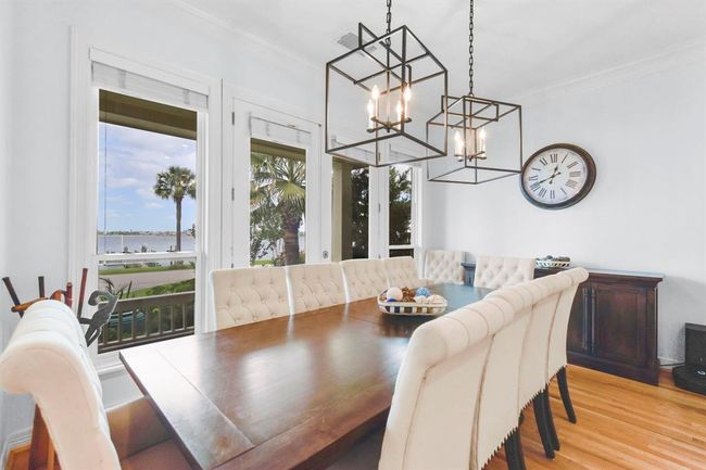 The dining room offers stunning views and direct access to the kitchen for easy serving. | Image 16
