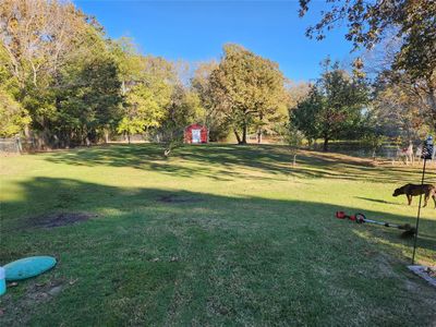 Surrounding community with a lawn and a storage shed | Image 3