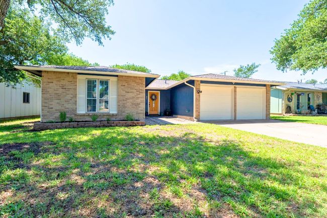 Ranch-style home featuring a garage, brick siding, a front lawn, and concrete driveway | Image 4
