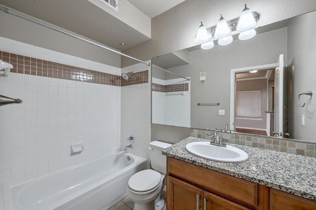 Full bathroom featuring bathing tub / shower combination and vanity | Image 22
