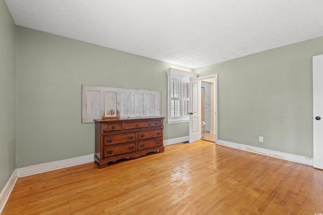 Bedroom featuring light wood-type flooring and baseboards | Image 8