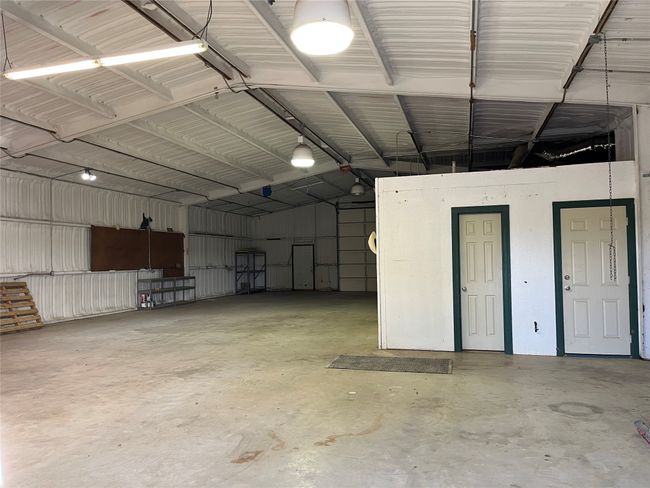 Garage Area with Half Bath and Storage Closet | Image 18