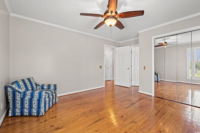 Unfurnished room featuring ceiling fan, wood-type flooring, and ornamental molding | Image 15