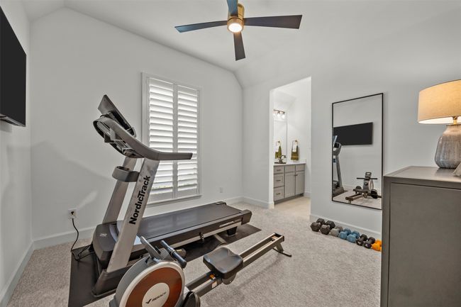 Exercise room with lofted ceiling, a ceiling fan, plenty of natural light, and carpet flooring | Image 28