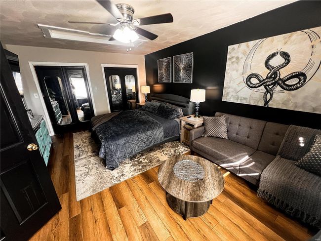 Bedroom with wood finished floors and a ceiling fan | Image 21