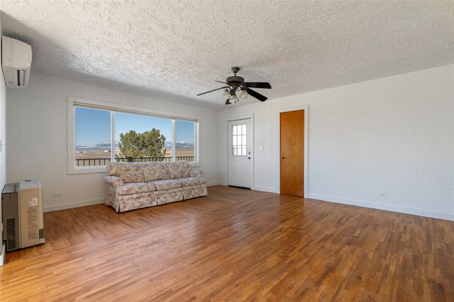 Spacious open-concept living room with abundant natural light. | Image 28