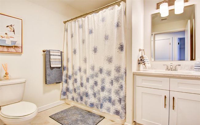 Bathroom featuring tile patterned floors, toilet, a shower with shower curtain, baseboards, and vanity | Image 21
