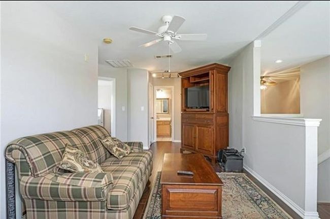 Living room with hardwood / wood-style floors and ceiling fan | Image 12