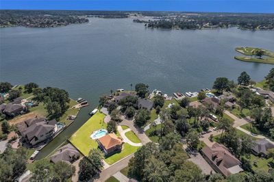 Look at this amazing yard, with over 160' lakeront, room to roam, plus owners driveway leading to the garage and a large circle drive for guests out front. Space, privacy & views! | Image 1