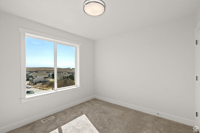 Carpeted empty room featuring baseboards | Image 27