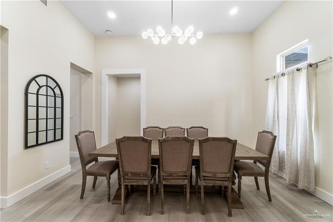Dining area featuring a chandelier and light hardwood / wood-style flooring | Image 25