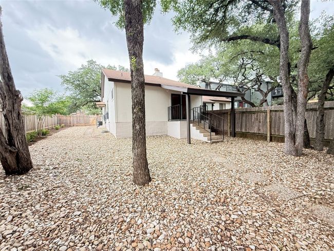 Rear view of home and yard as seen from the fencing area | Image 28