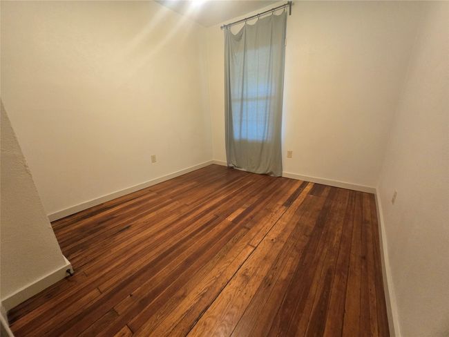 Spare room with dark wood finished floors and baseboards | Image 16