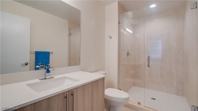 Bathroom with vanity, toilet, and walk in shower | Image 5