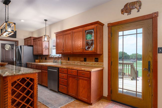 Large kitchen exits to a deck for viewing the sunrises | Image 29