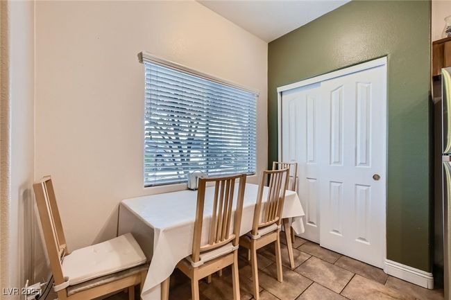 Dining area between the front door and kitchen pantry area, under a window looking out the front of the unit. | Image 4