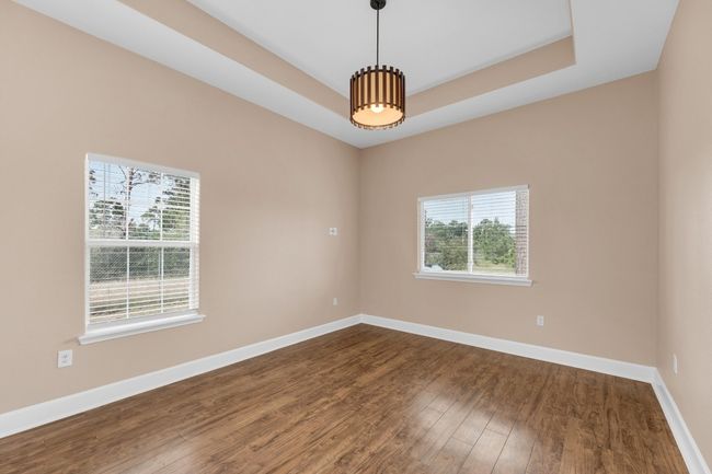 Empty room with a tray ceiling and dark wood-style flooring | Image 27