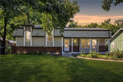 Back house at dusk with a yard | Image 1