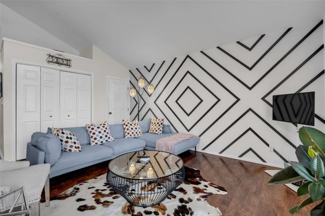 Living room featuring lofted ceiling and wood finished floors | Image 25