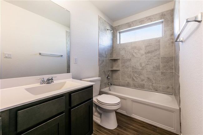 Bathroom featuring vanity, wood finished floors, and shower combination | Image 19