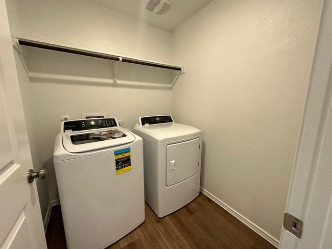 Laundry room featuring independent washer and dryer and dark wood-style floors | Image 28