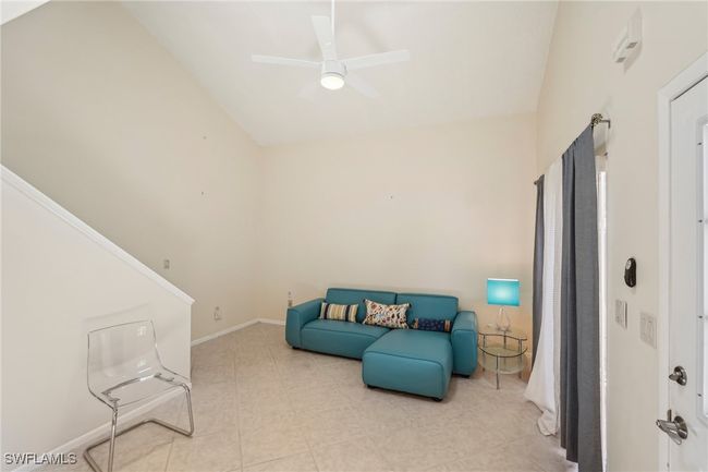 Sitting room with a ceiling fan and baseboards | Image 9