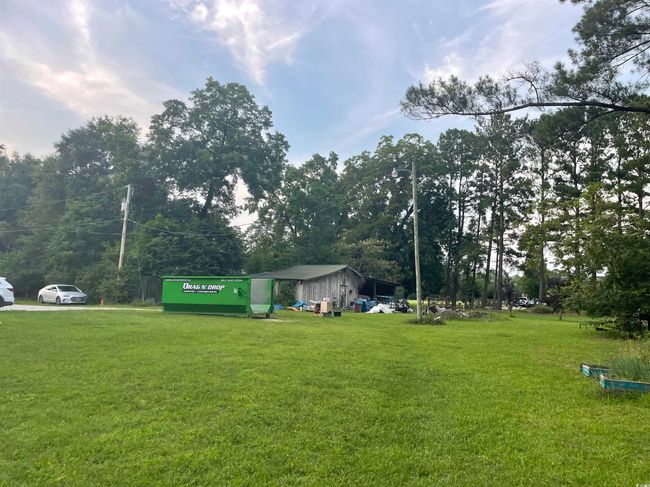 View of green lawn with view of wooded area | Image 40
