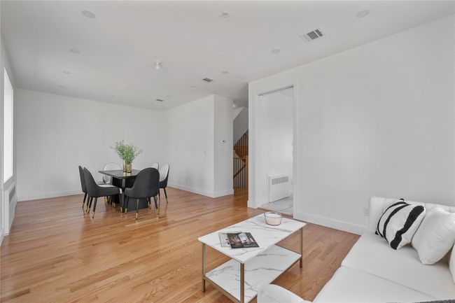 Living room with light wood-style flooring, visible vents, and baseboards | Image 16