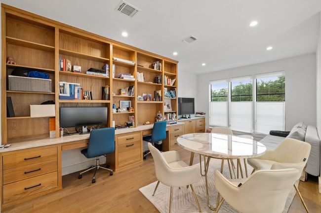 Home office featuring built in desk, light wood-style floors, and recessed lighting | Image 20