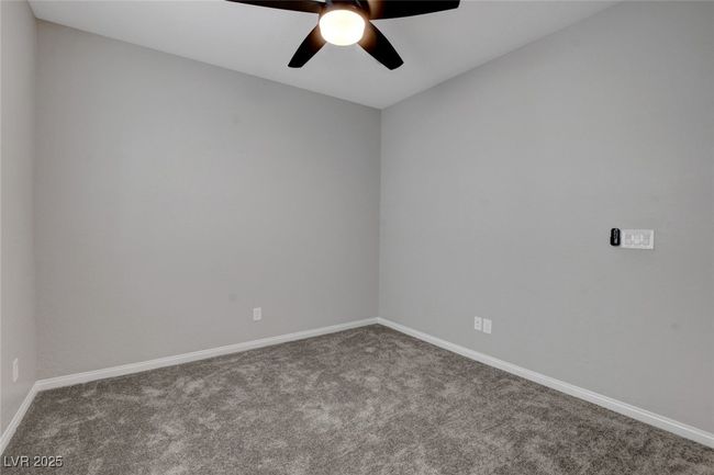 Spare room featuring carpet, baseboards, and ceiling fan | Image 12