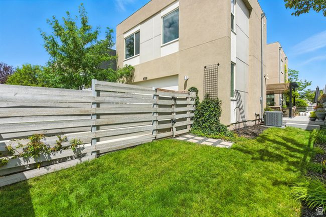 View of property exterior with stucco siding and a central AC unit | Image 45