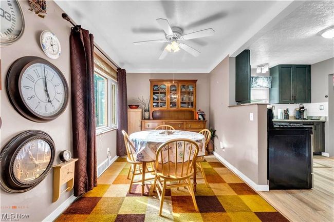 Dining space with ceiling fan, baseboards, and light floors | Image 10